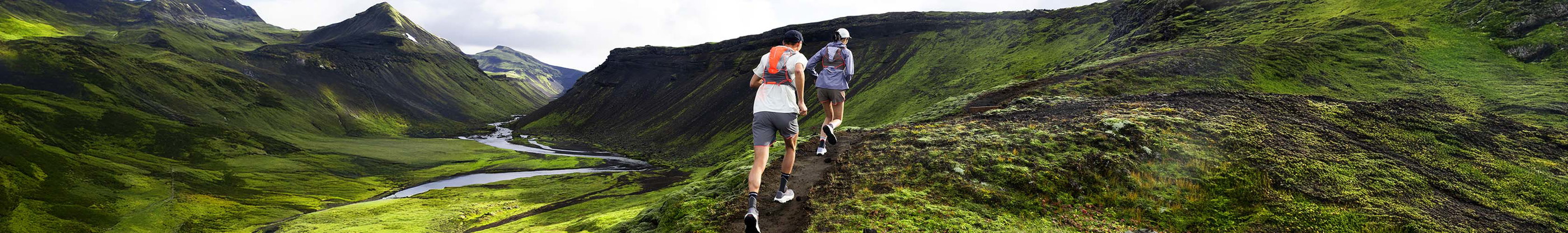 Shop accessories new season. Two runners running on a mountain 