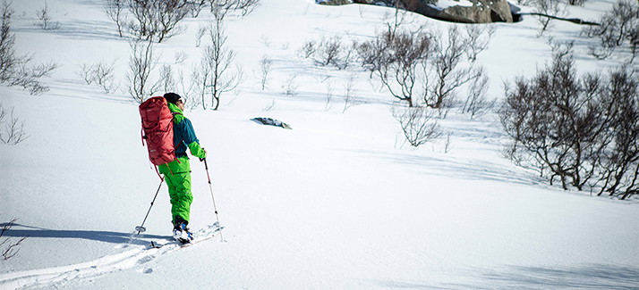 A man wearing an avalanche pack in the snow 