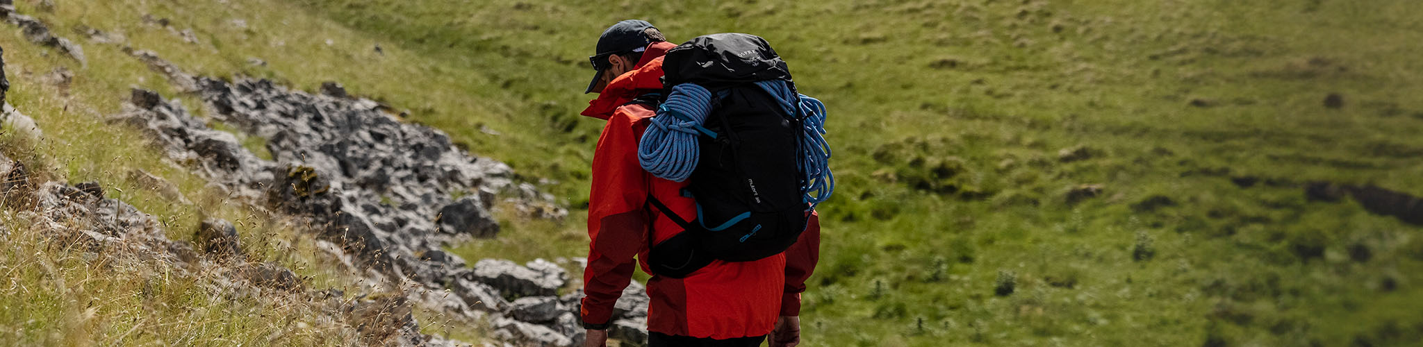 Shop equipment. A man hiking with a rucksack and ropes.