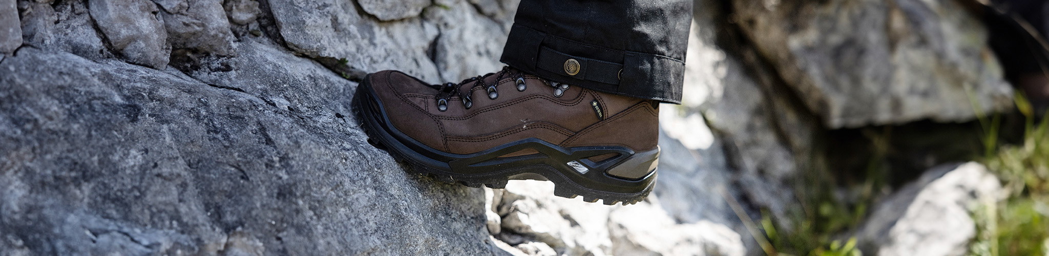 Shop footwear new season. A person wearing walking boots 
