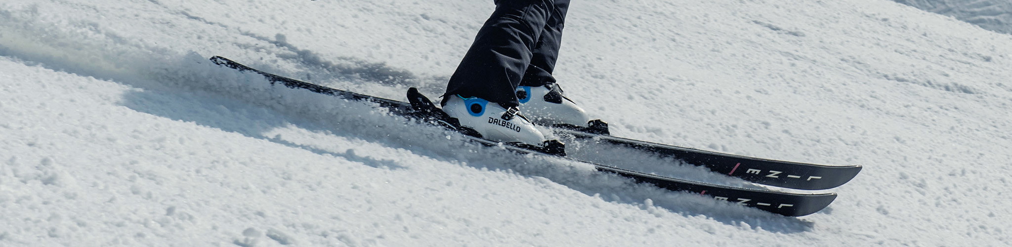 Shop ski boots. A person skiing on snowy mountain