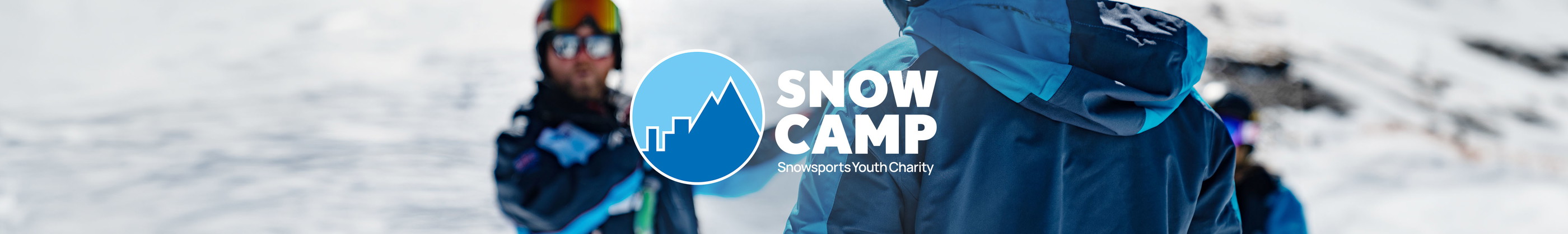 Snow Camp. People are in a ski resort, wearing skiing gear.  