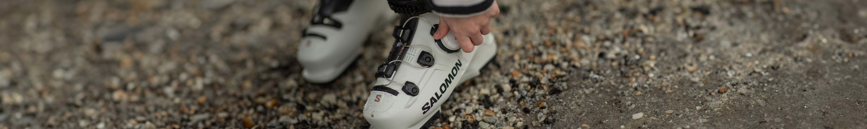 An image of a person tightening their ski boot with their BOA device
