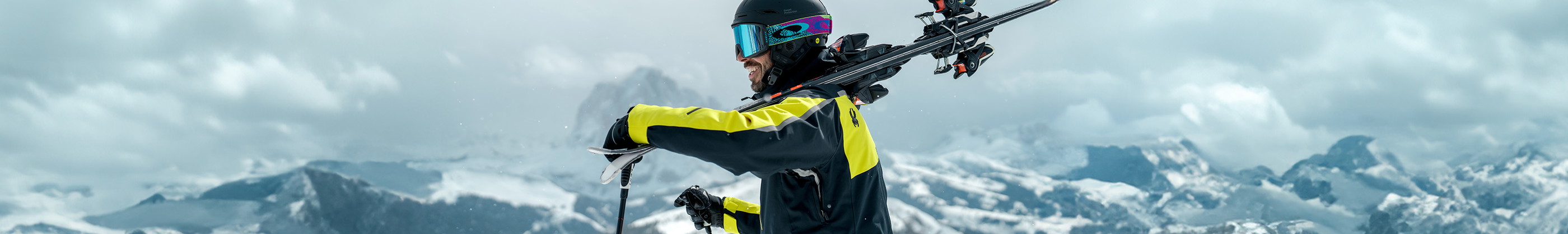 Shop Snowsport equipment new season. Man carrying skiies over his shoulder. 